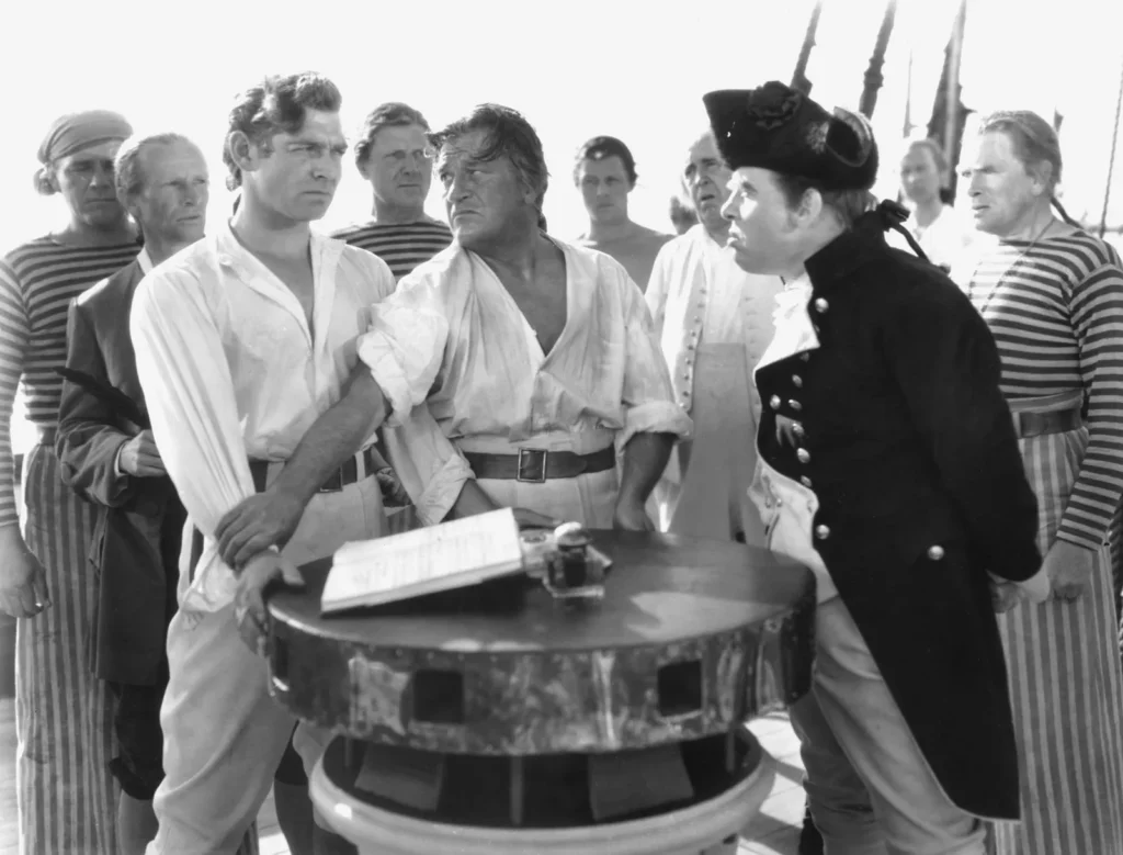 Clark Gable e Charles Laughton em cena de O Grande Motim (1935). Ambos os atores foram indicados ao Oscar de Melhor Ator. Distribuição: Metro-Goldwyn-Mayer.